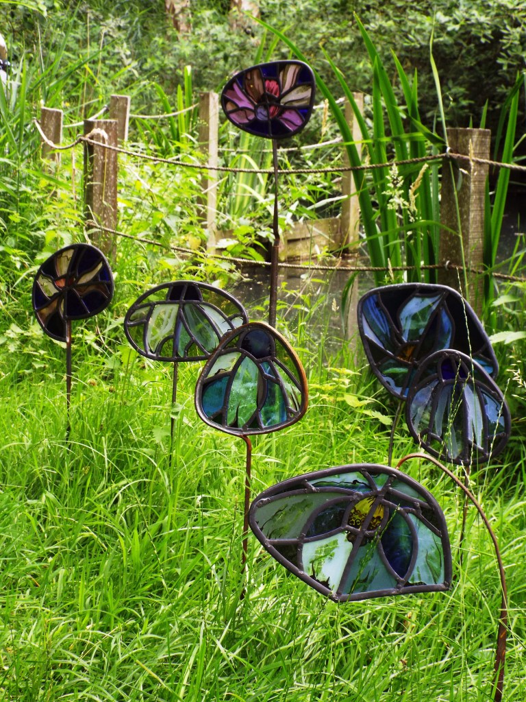 stained glass flower stakes in the garden